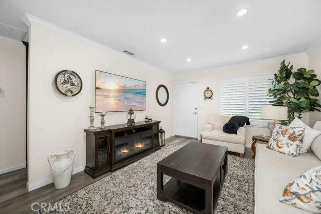 a living room with furniture a rug and a fireplace