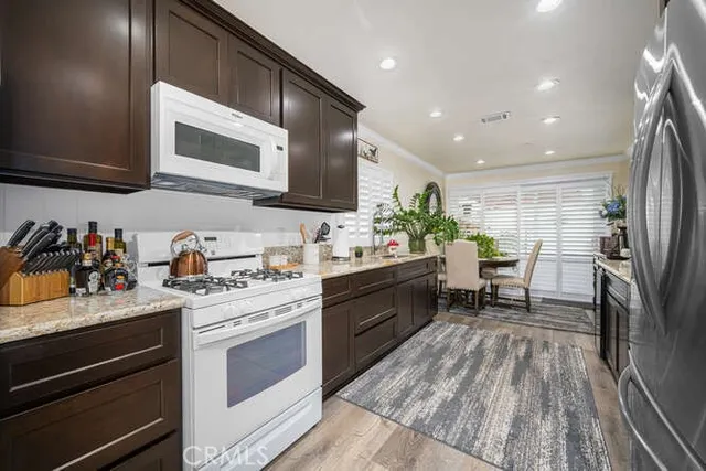 a kitchen with a sink microwave and cabinets