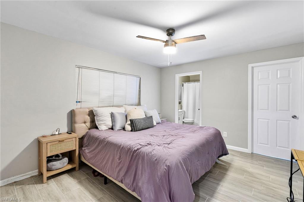 8264-8268 Matanzas Road Fort Myers, FL 33967 - Photo 10 of 33 a bedroom with a bed and a chandelier