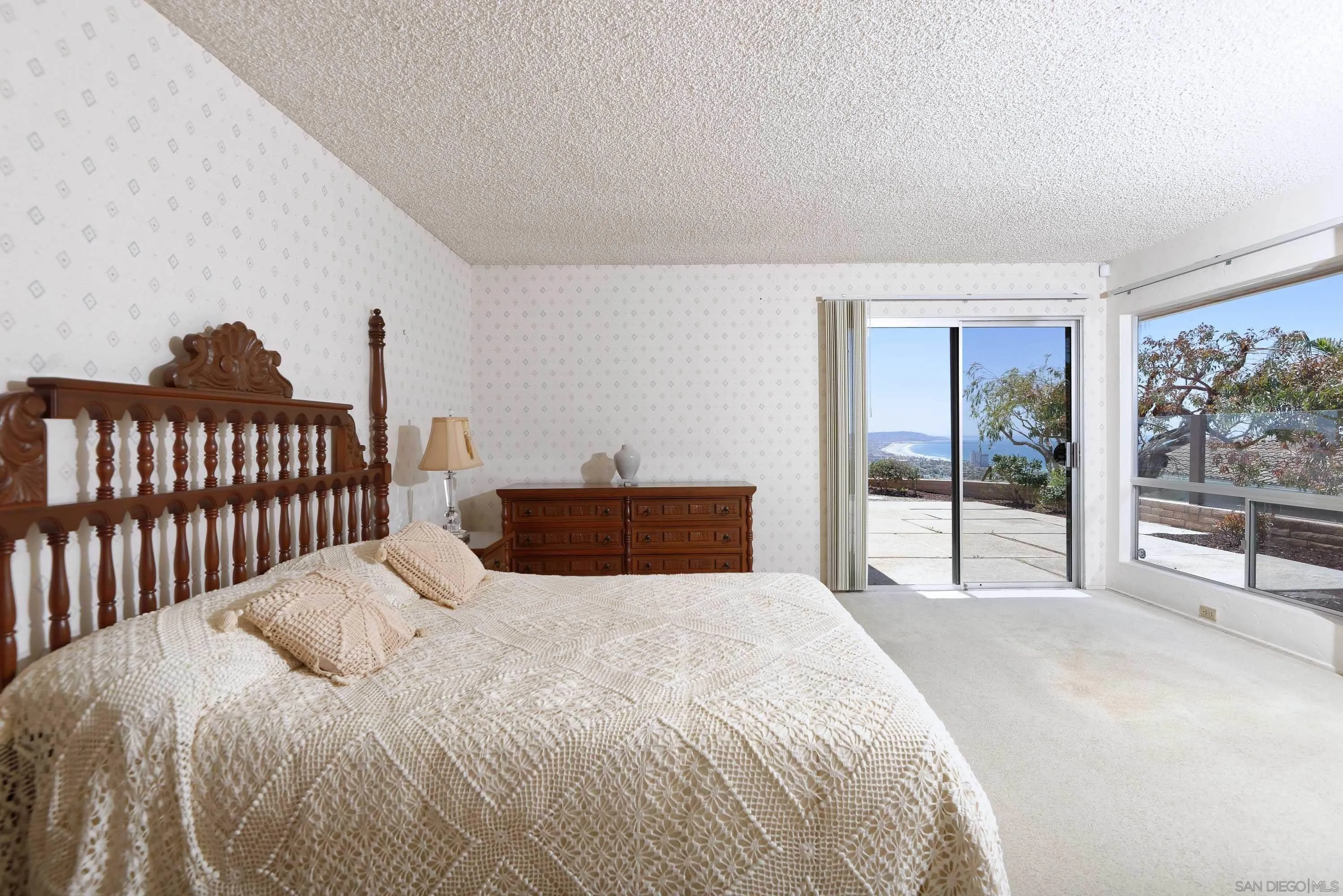 5571 Candlelight Drive La Jolla, CA 92037 - Photo 15 of 25 a bedroom with a large bed and a tv