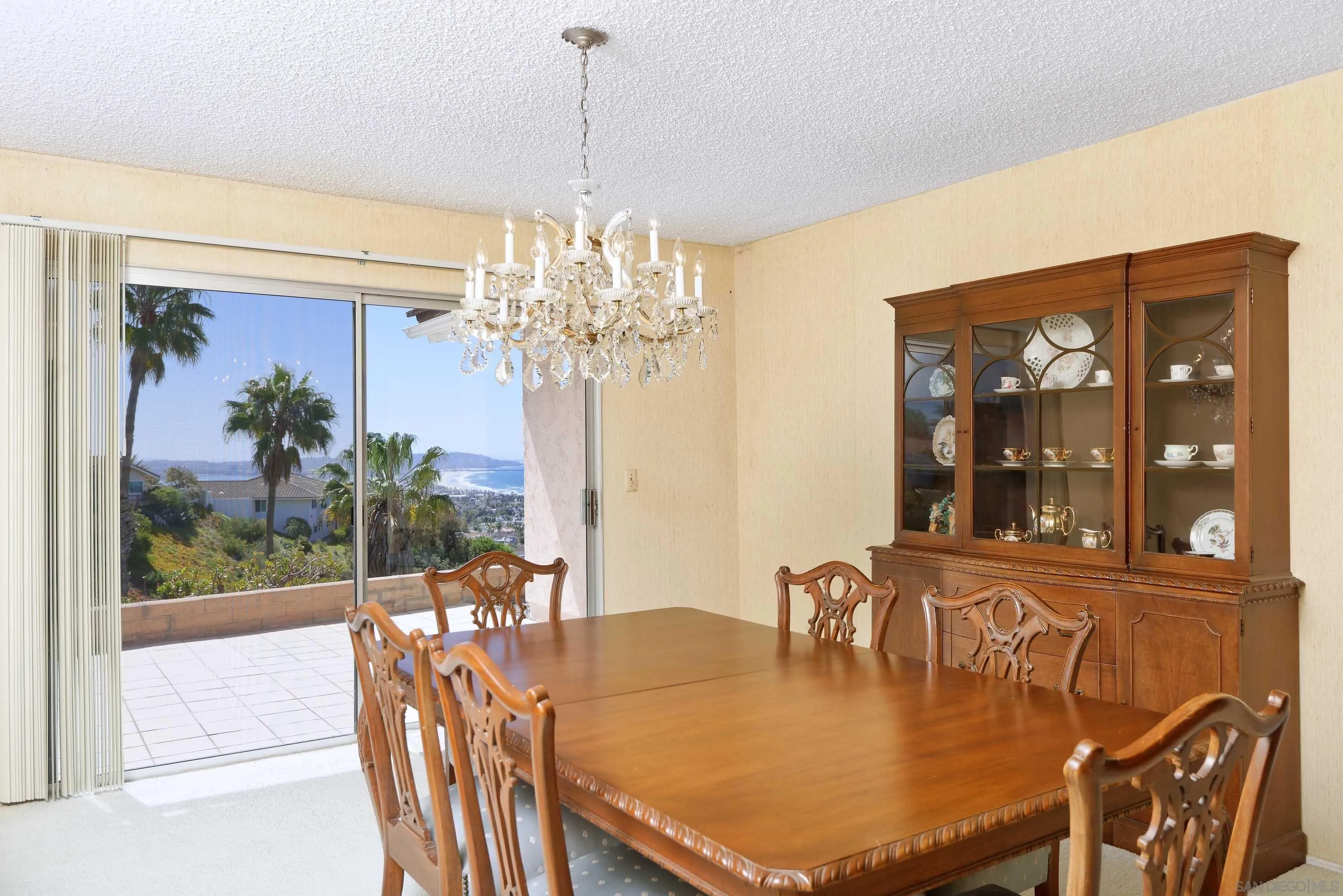 5571 Candlelight Drive La Jolla, CA 92037 - Photo 8 of 25 a dining room with furniture a chandelier and window