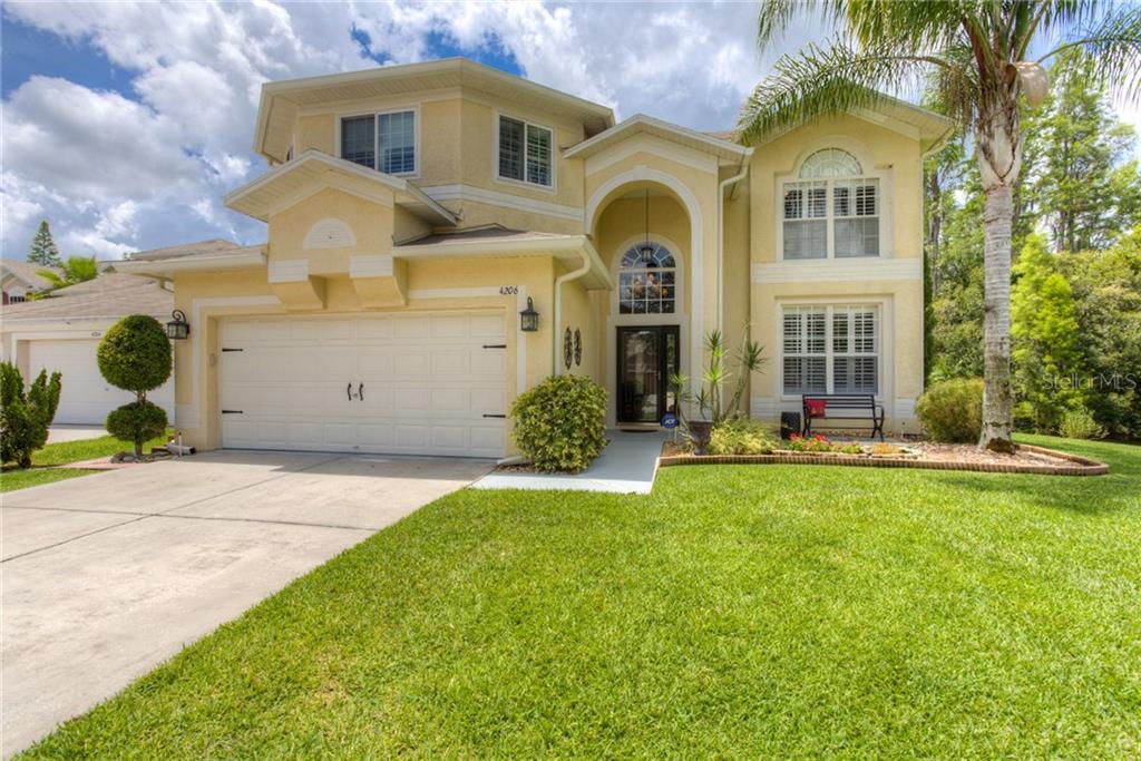 4206 Fishermans Lake Drive Lutz, FL 33558 - Photo 1 of 1 a front view of a house with garden