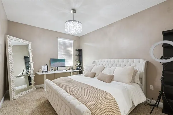 a bedroom with a bed and a ceiling fan