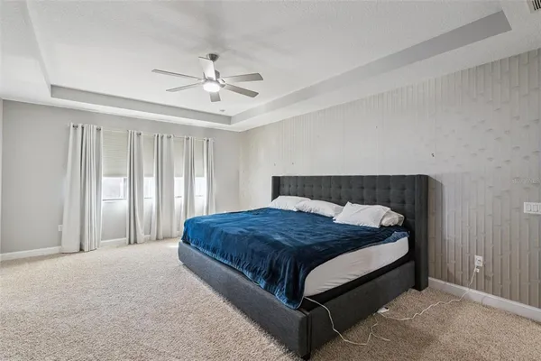 a bedroom with a large bed and a flat screen tv