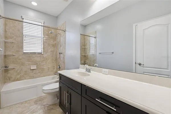 a bathroom with a sink a mirror and a shower