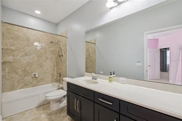 a bathroom with double vanity and a bathtub