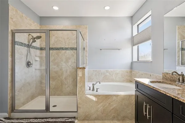 a bathroom with a double vanity sink mirror and shower