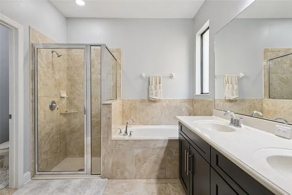 a bathroom with a sink toilet a mirror and shower