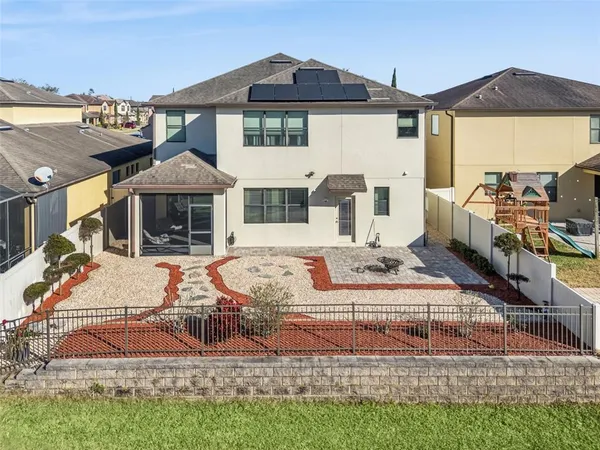 an aerial view of a house with a yard