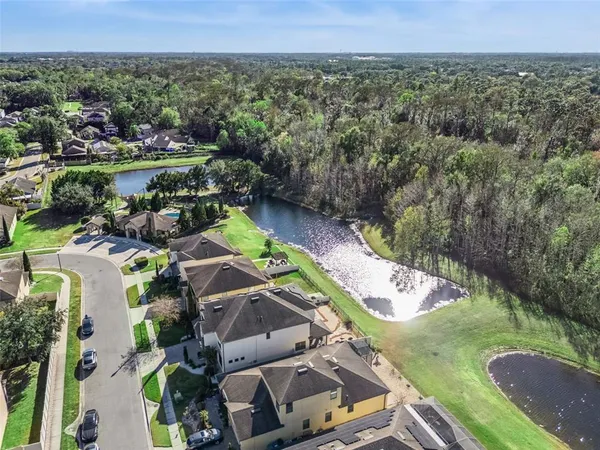 an aerial view of residential houses with outdoor space