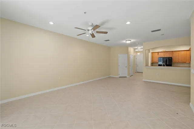 an empty room with a empty space and a ceiling fan