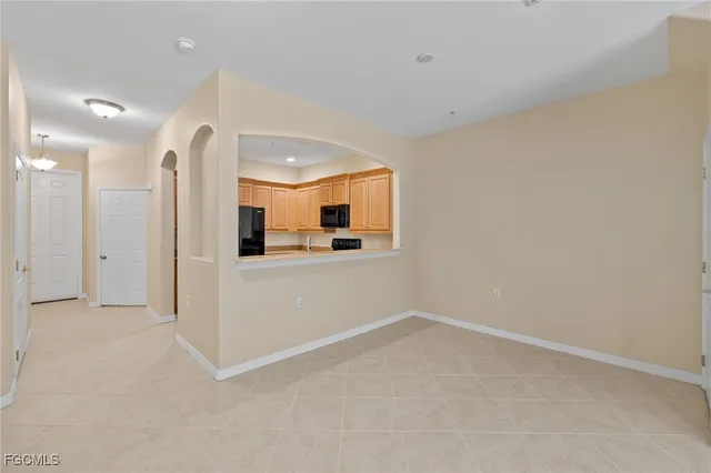 an empty room with a bathroom and a mirror