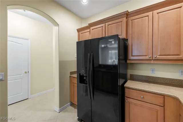 a kitchen with a refrigerator cabinet and cabinets