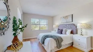 a bed sitting in a bedroom and lamp