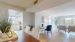 a view of a dining room with furniture and a potted plant