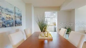 a living room with furniture floor to ceiling window and wooden floor