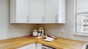 a kitchen with granite countertop white cabinets and white appliances