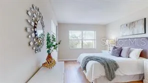 a view of a room with wooden floor and a bathroom