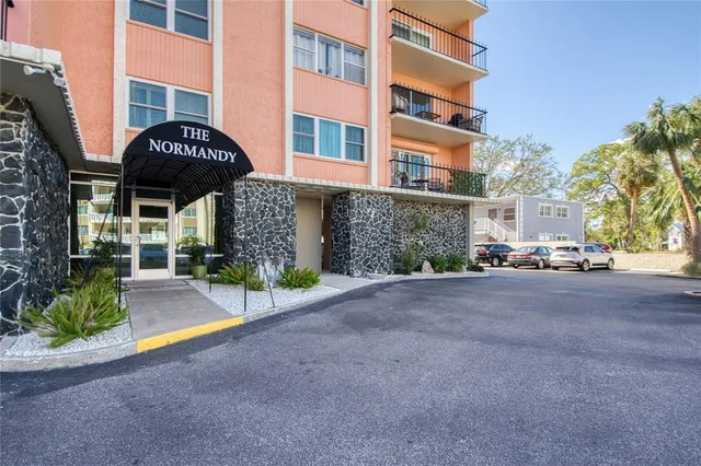 a sign that is sitting in front of flowers