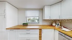 a kitchen with a sink cabinets and window