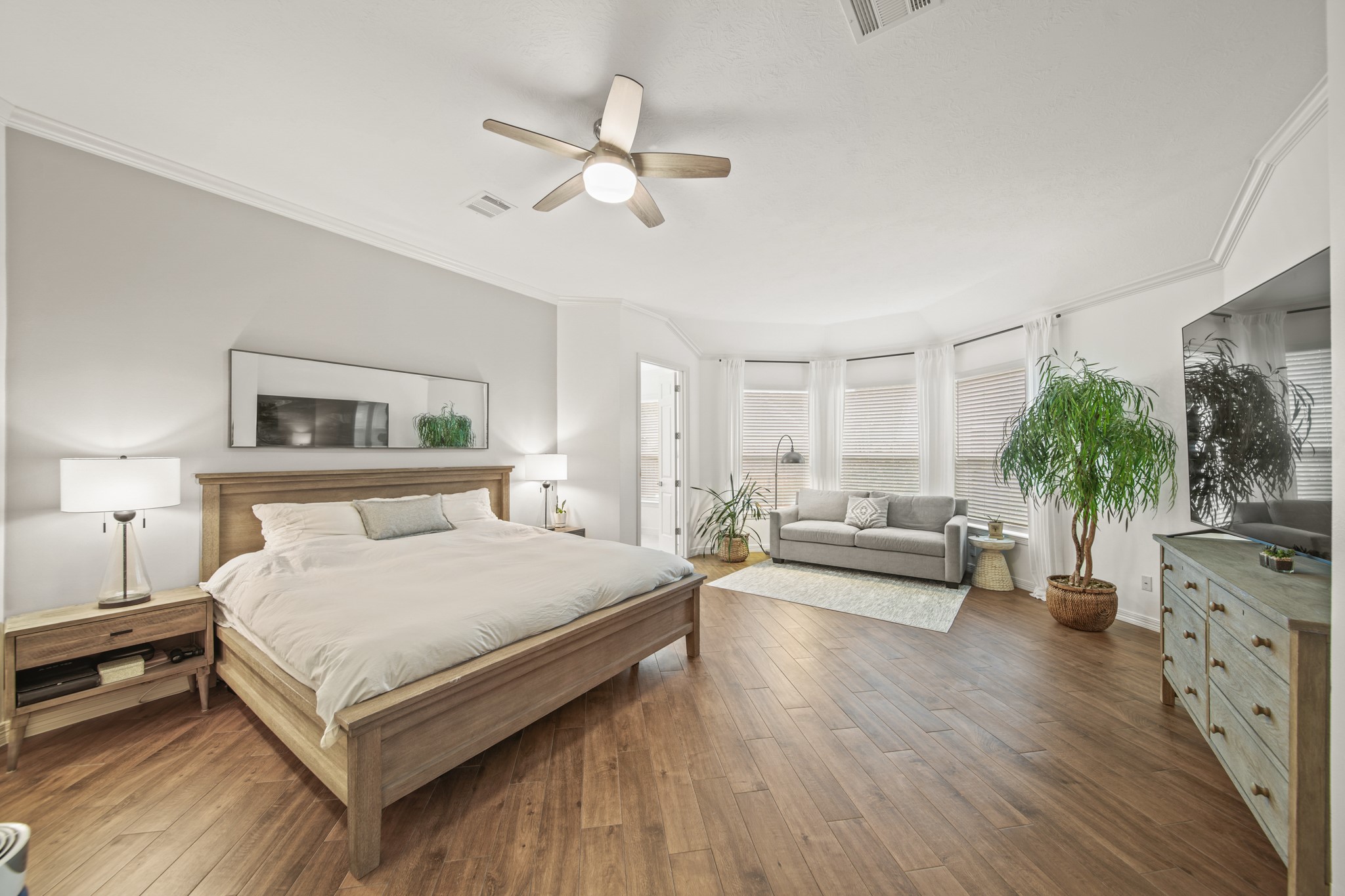 12210 Pebble Meadows Houston, TX 77041 - Photo 12 of 28 Extra spacious, light-filled primary bedroom with a cozy sitting area, bay windows, and a calm, modern aesthetic