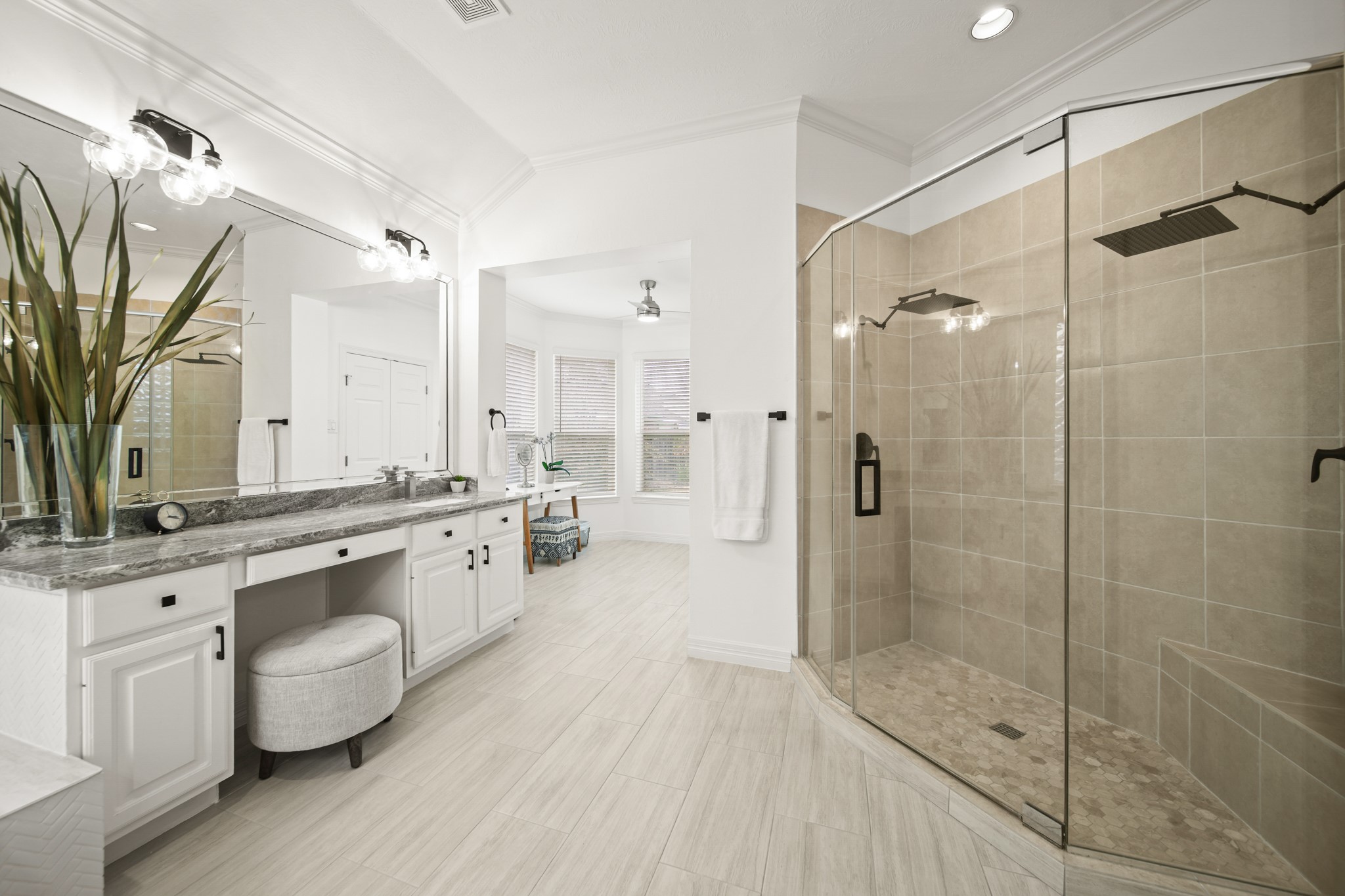12210 Pebble Meadows Houston, TX 77041 - Photo 13 of 28 A large, newly updated primary bathroom with dual vanities, a walk-in double shower with oversized shower heads, a soaking tub, and a bright, spacious layout