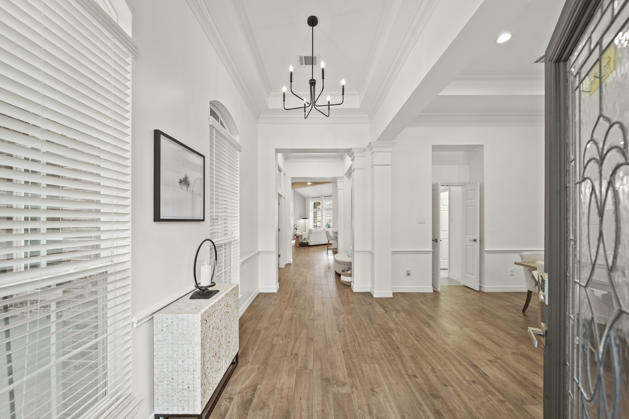 12210 Pebble Meadows Houston, TX 77041 - Photo 2 of 28 Bright and welcoming entryway with soaring 12-foot ceilings, beautiful flooring throughout, elegant crown molding, and a modern chandelier