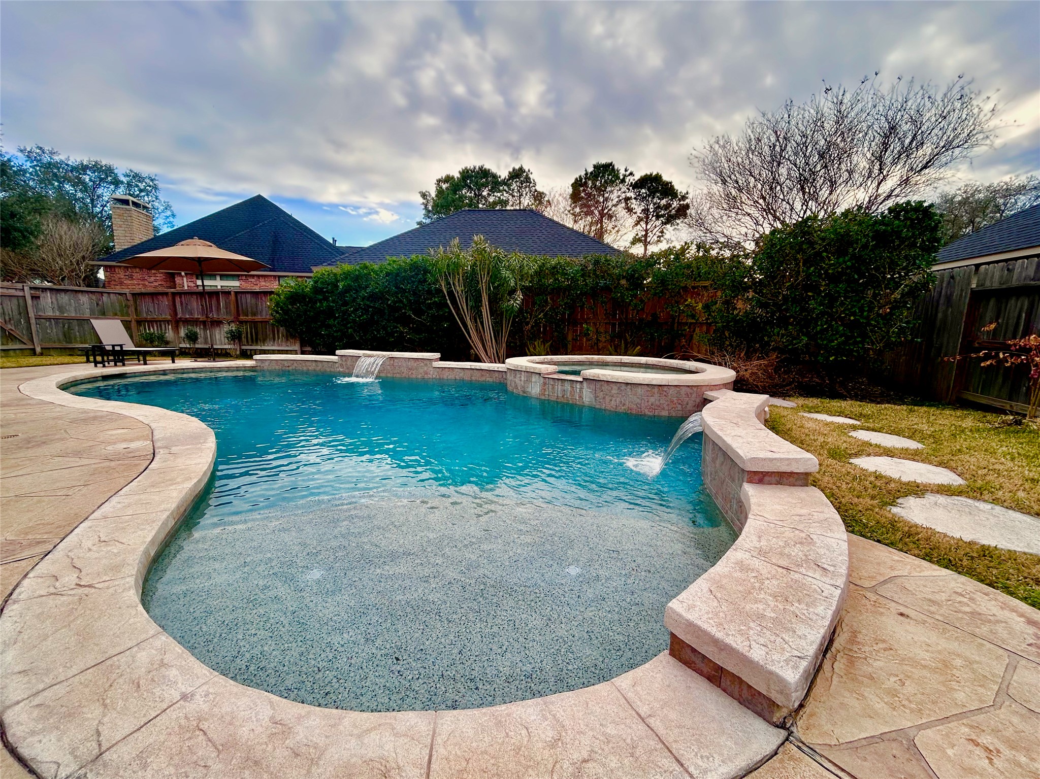 12210 Pebble Meadows Houston, TX 77041 - Photo 21 of 28 A beautiful, full-sized heated pool and hot tub, perfect for relaxing and enjoying the outdoors year-round