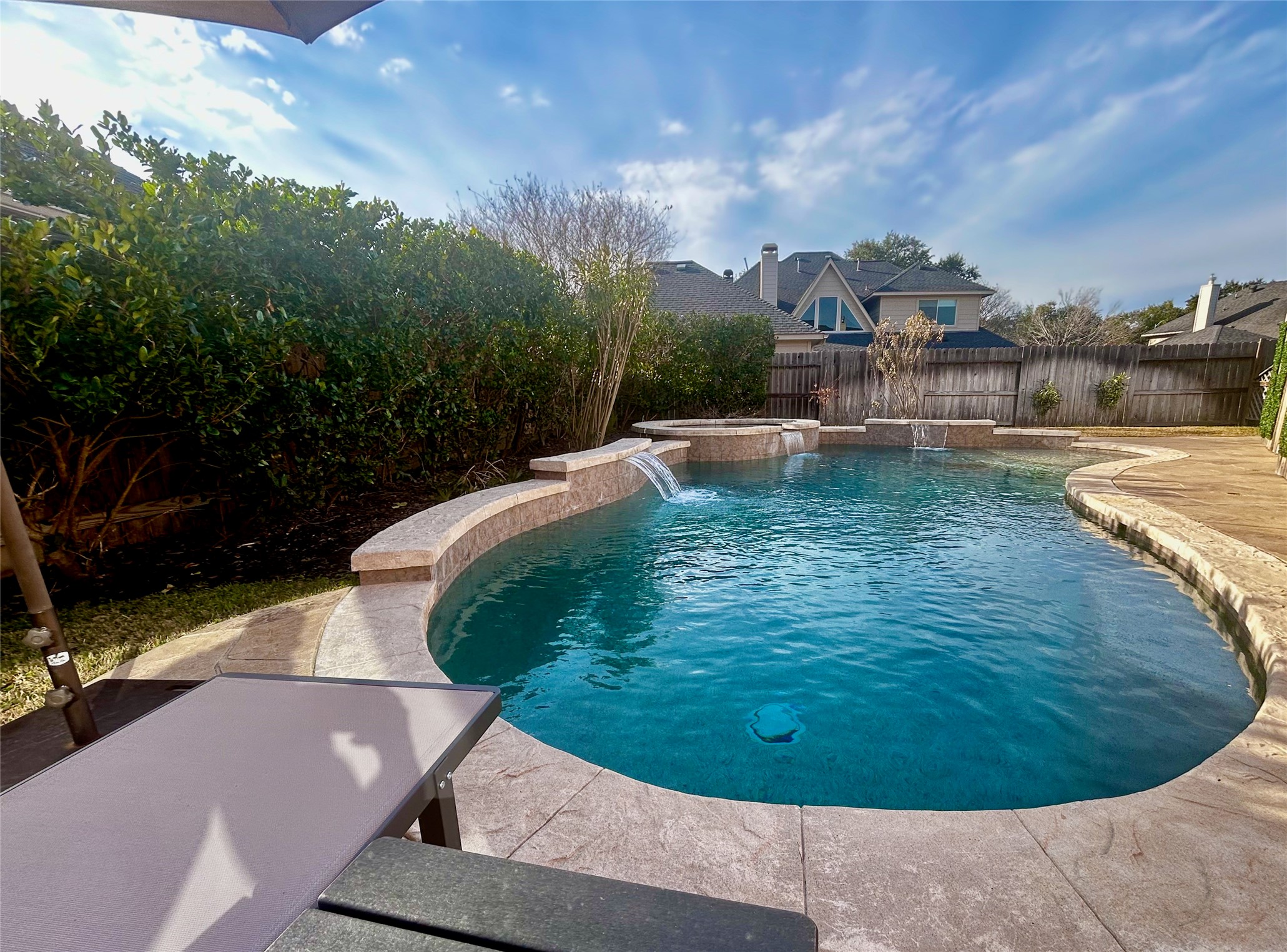 12210 Pebble Meadows Houston, TX 77041 - Photo 22 of 28 Sunbathe by your private pool and hot tub with resort-style lounge seating and a large umbrella.