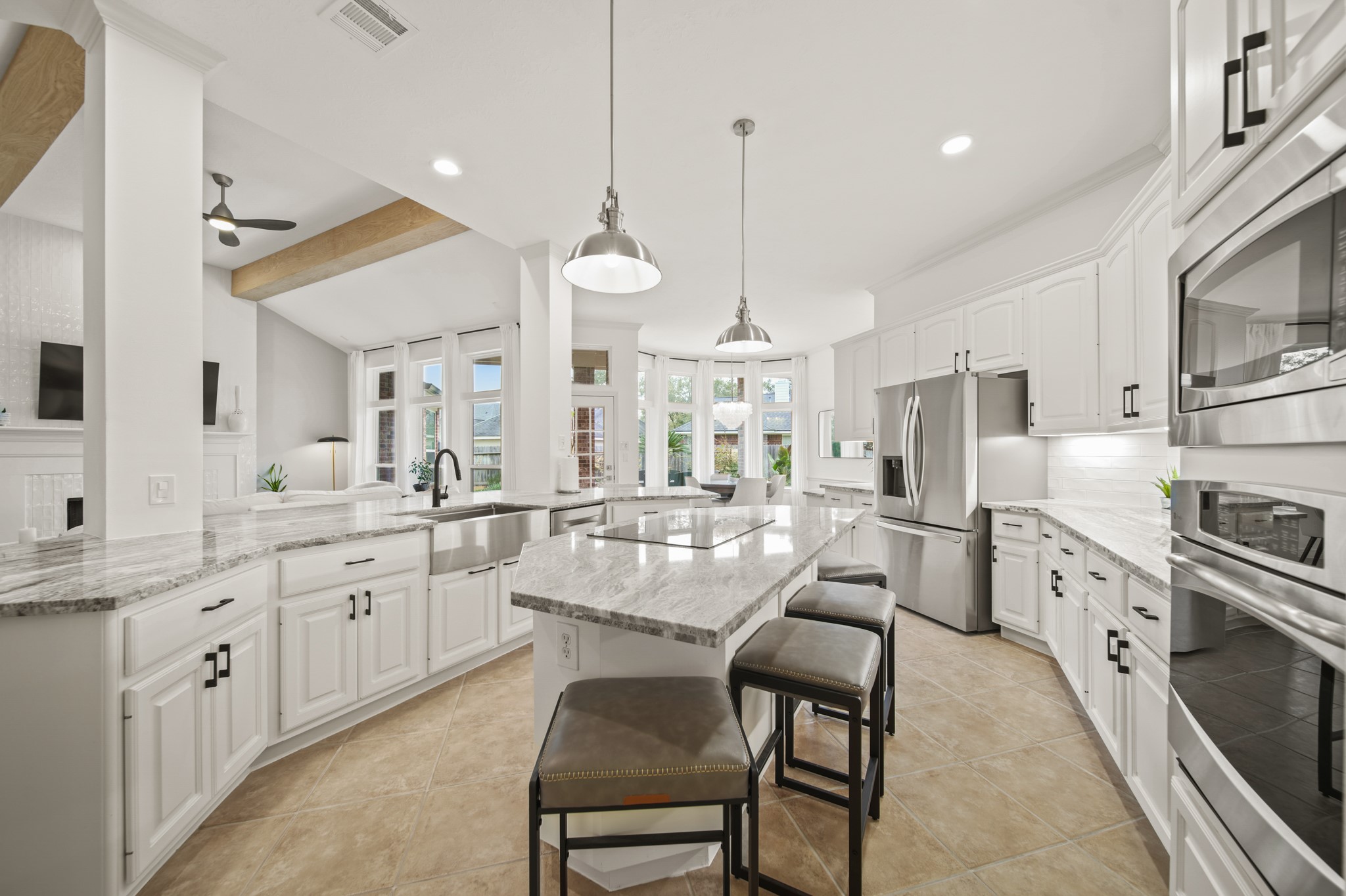 12210 Pebble Meadows Houston, TX 77041 - Photo 7 of 28 a large kitchen with white cabinets and stainless steel appliances