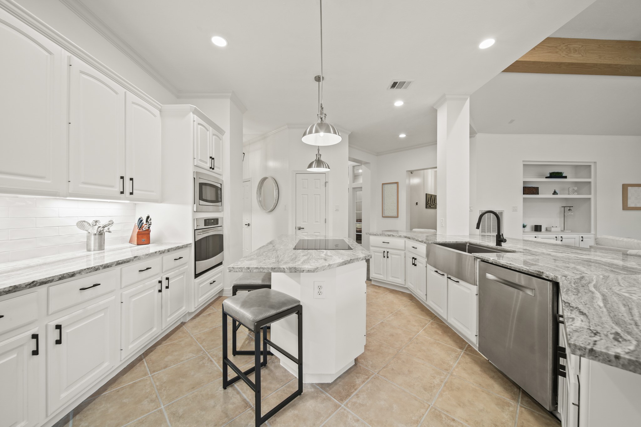 12210 Pebble Meadows Houston, TX 77041 - Photo 8 of 28 a large white kitchen with lots of counter space a sink and appliances