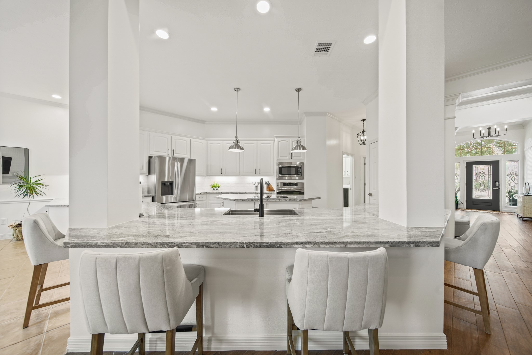 12210 Pebble Meadows Houston, TX 77041 - Photo 9 of 28 a kitchen with kitchen island granite countertop a table and chairs