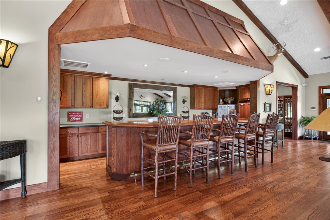 1230 Melton Road, Unit 4 West Union, SC 29696 - Photo 10 of 48 Entertaining space features a well-appointed bar area with rich wood cabinetry and gleaming hardwood flooring.