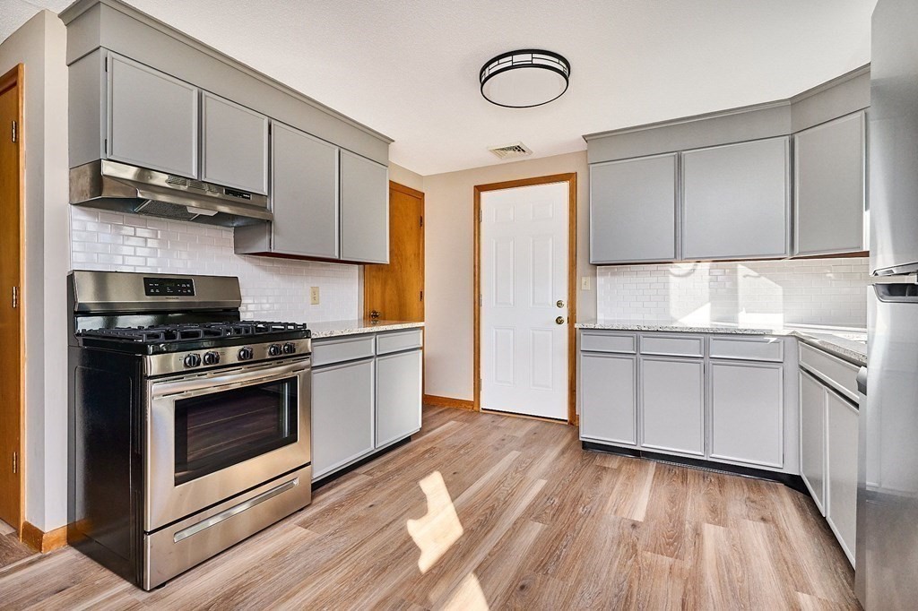 56 Thaddeus Street Chicopee, MA 01020 - Photo 3 of 24 a kitchen with stainless steel appliances granite countertop a stove and a refrigerator