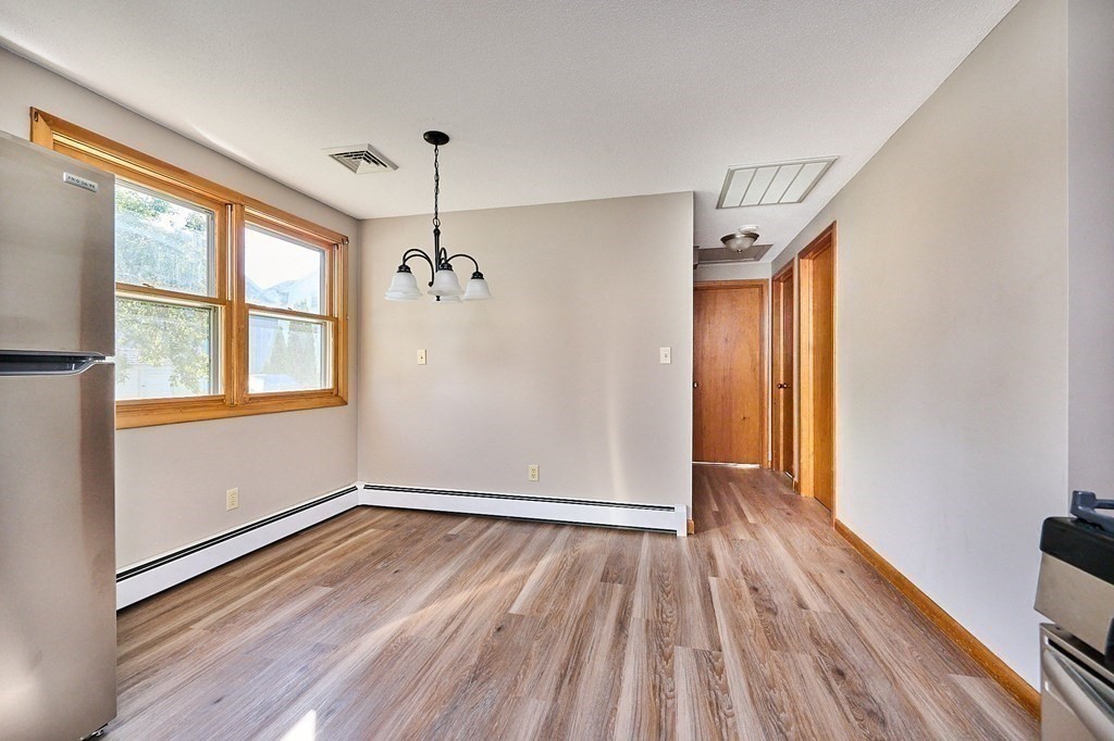 56 Thaddeus Street Chicopee, MA 01020 - Photo 5 of 24 a view of an empty room with wooden floor and a window