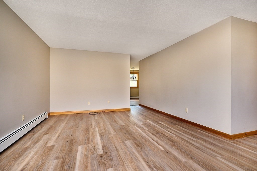 56 Thaddeus Street Chicopee, MA 01020 - Photo 6 of 24 a view of an empty room with wooden floor