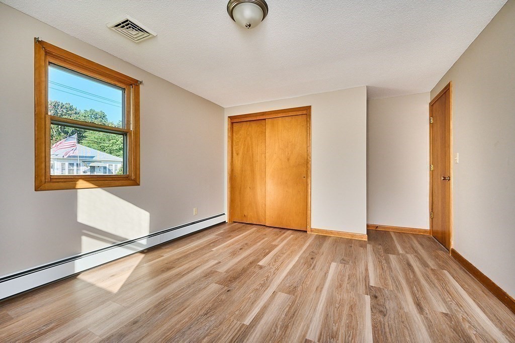 56 Thaddeus Street Chicopee, MA 01020 - Photo 9 of 24 a view of an empty room with wooden floor and a window