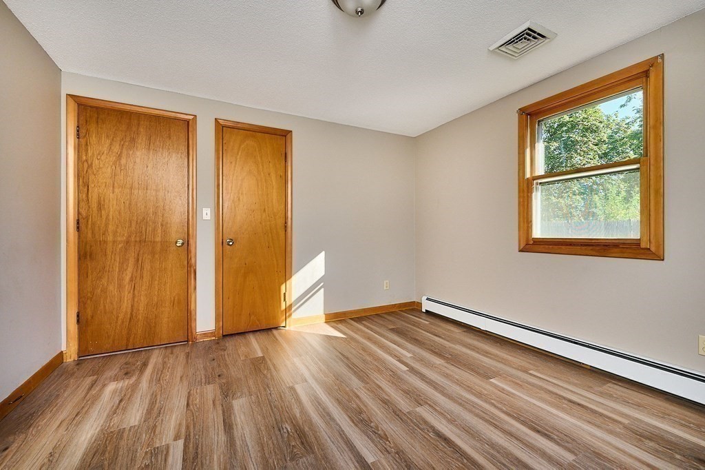 56 Thaddeus Street Chicopee, MA 01020 - Photo 10 of 24 a view of an empty room with wooden floor and a window