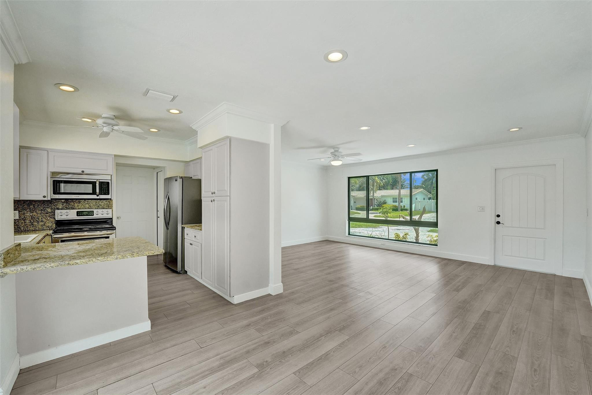 5001 Northeast 23rd Avenue Lighthouse Point, FL 33064 - Photo 13 of 34 a view of a kitchen with wooden floor and electronic appliances