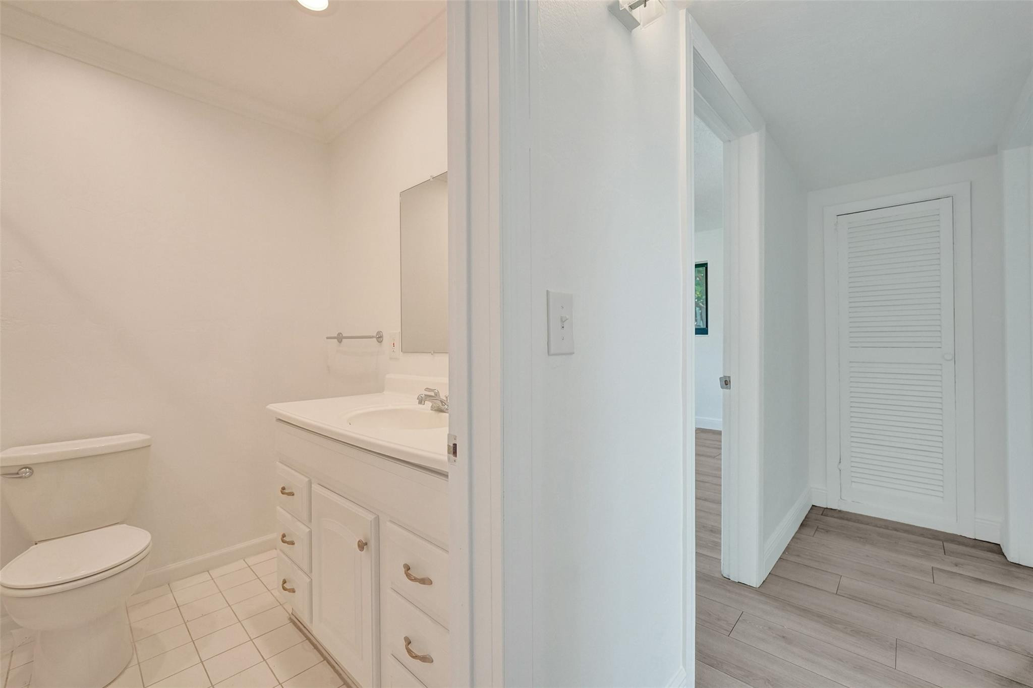 5001 Northeast 23rd Avenue Lighthouse Point, FL 33064 - Photo 18 of 34 a bathroom with a toilet a sink and mirror