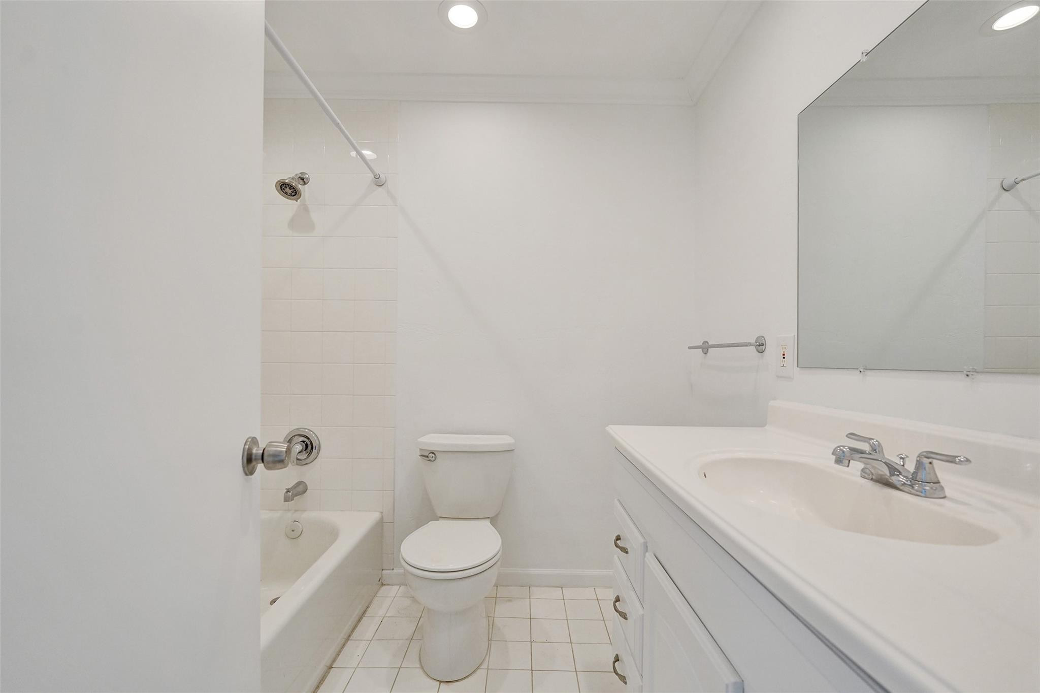 5001 Northeast 23rd Avenue Lighthouse Point, FL 33064 - Photo 19 of 34 a bathroom with a sink a toilet and shower