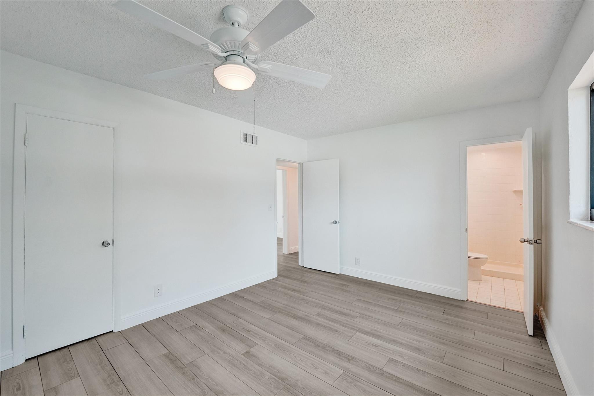 5001 Northeast 23rd Avenue Lighthouse Point, FL 33064 - Photo 23 of 34 a view of an empty room with wooden floor