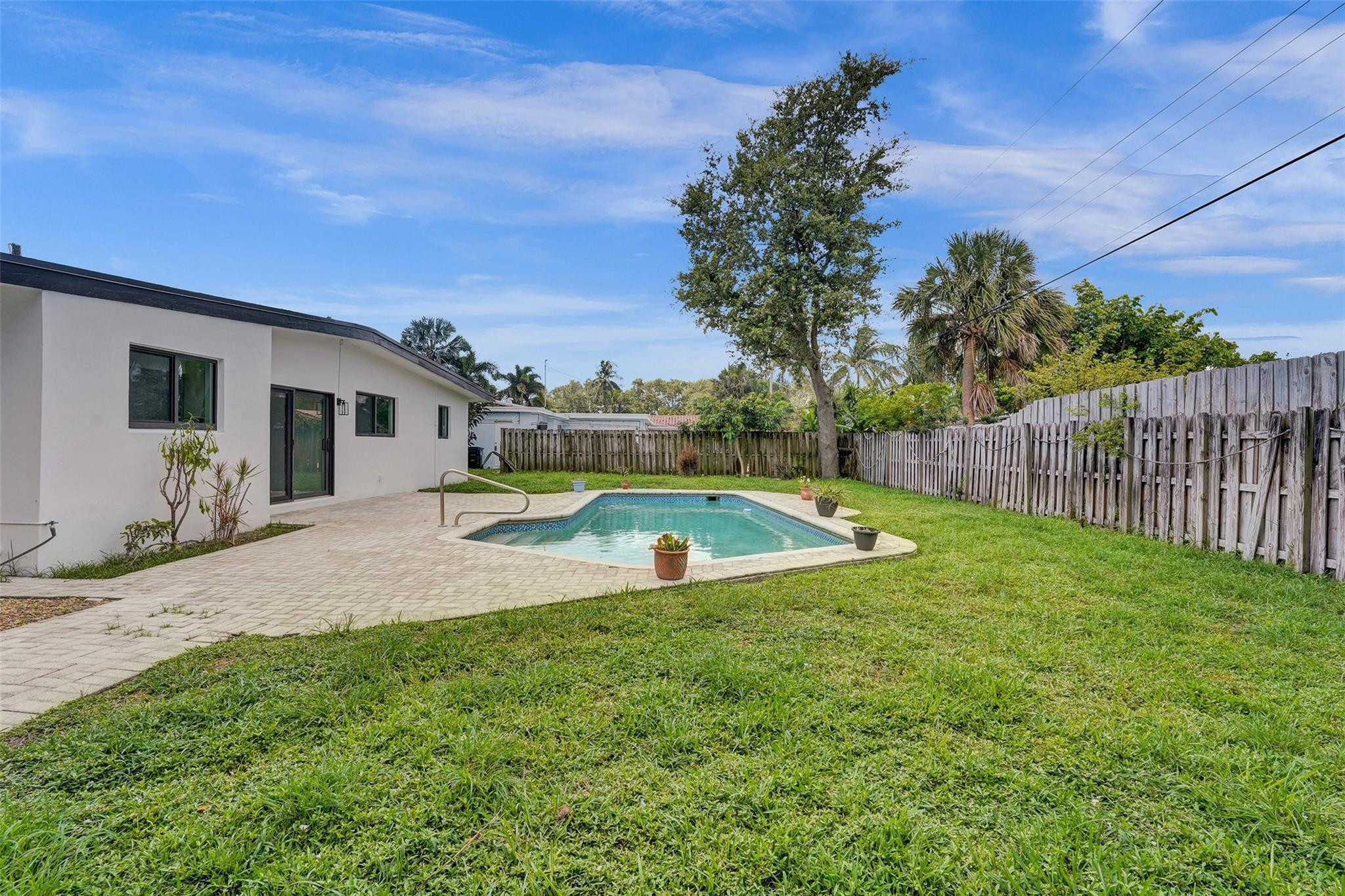 5001 Northeast 23rd Avenue Lighthouse Point, FL 33064 - Photo 26 of 34 a view of a house with swimming pool and porch