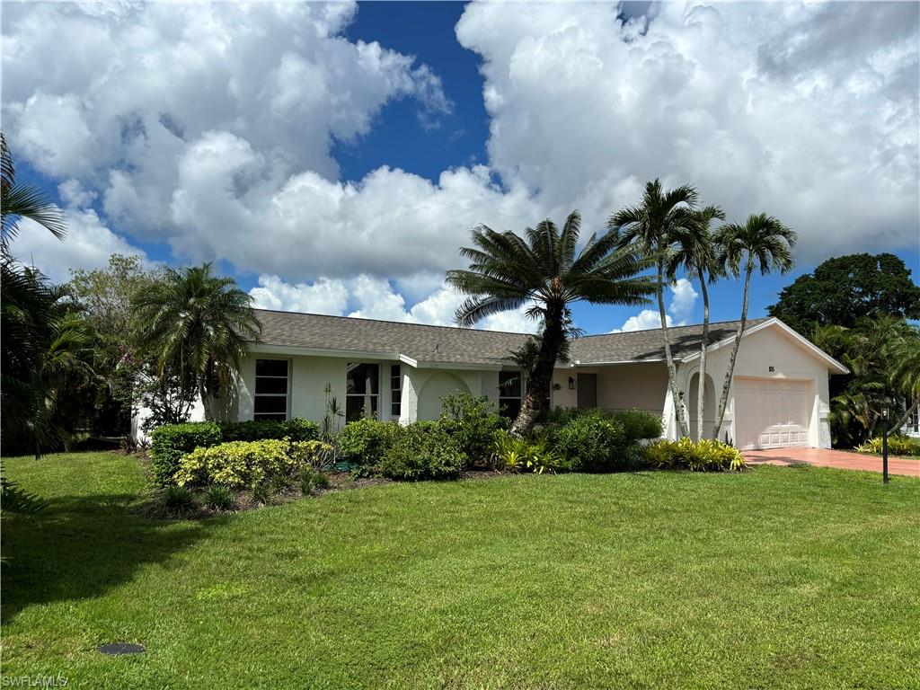 105 Blue Ridge Drive, Unit 20 Naples, FL 34112 - Photo 1 of 15 Ranch-style home featuring a garage and a front yard