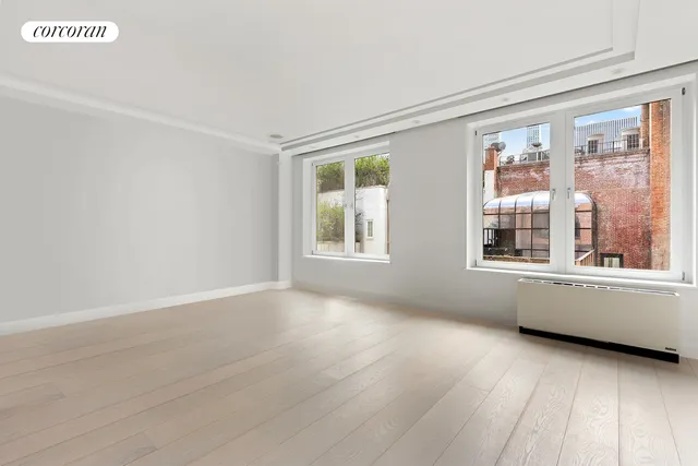 a living room with furniture a flat screen tv and kitchen view