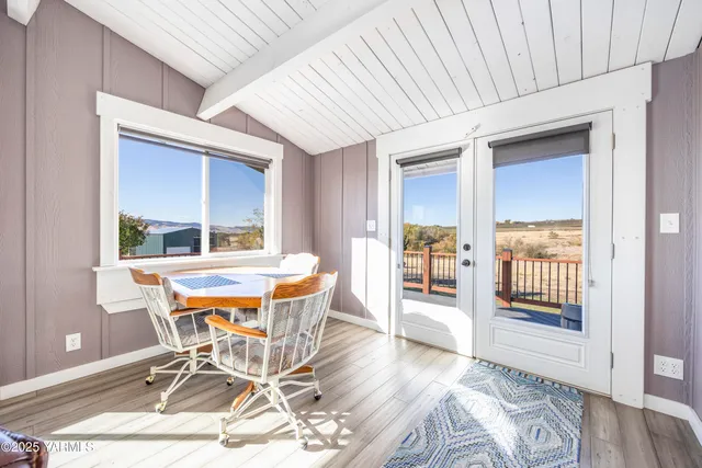 a kitchen with a sink dishwasher a stove and white cabinets with wooden floor