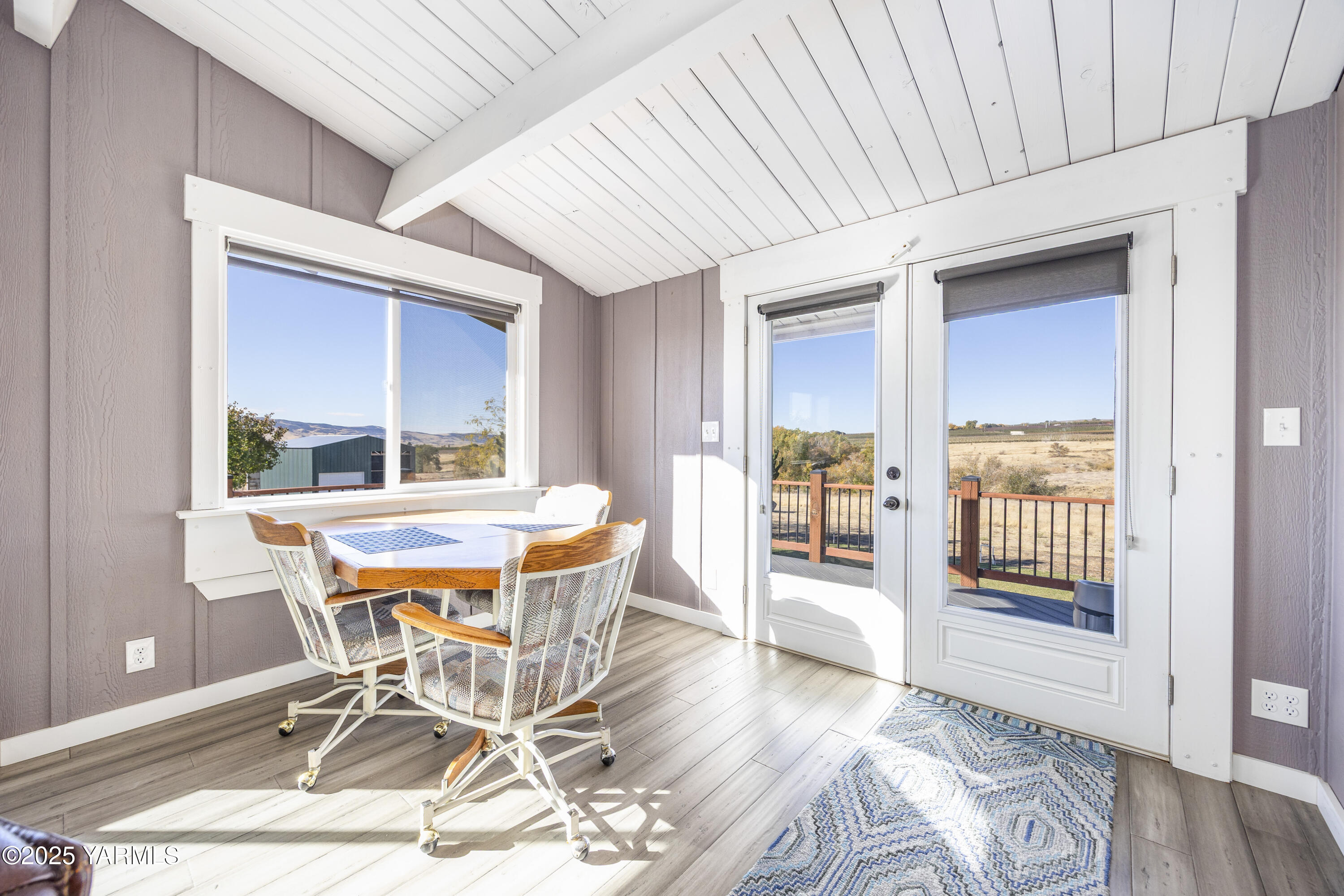 22207 West Gerrick Road Benton City, WA 99320 - Photo 25 of 60 a dining room with wooden floor and a table