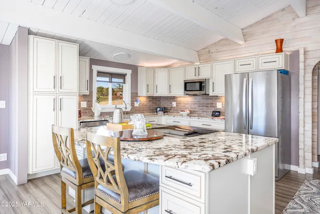 a kitchen with granite countertop a sink stove and cabinets