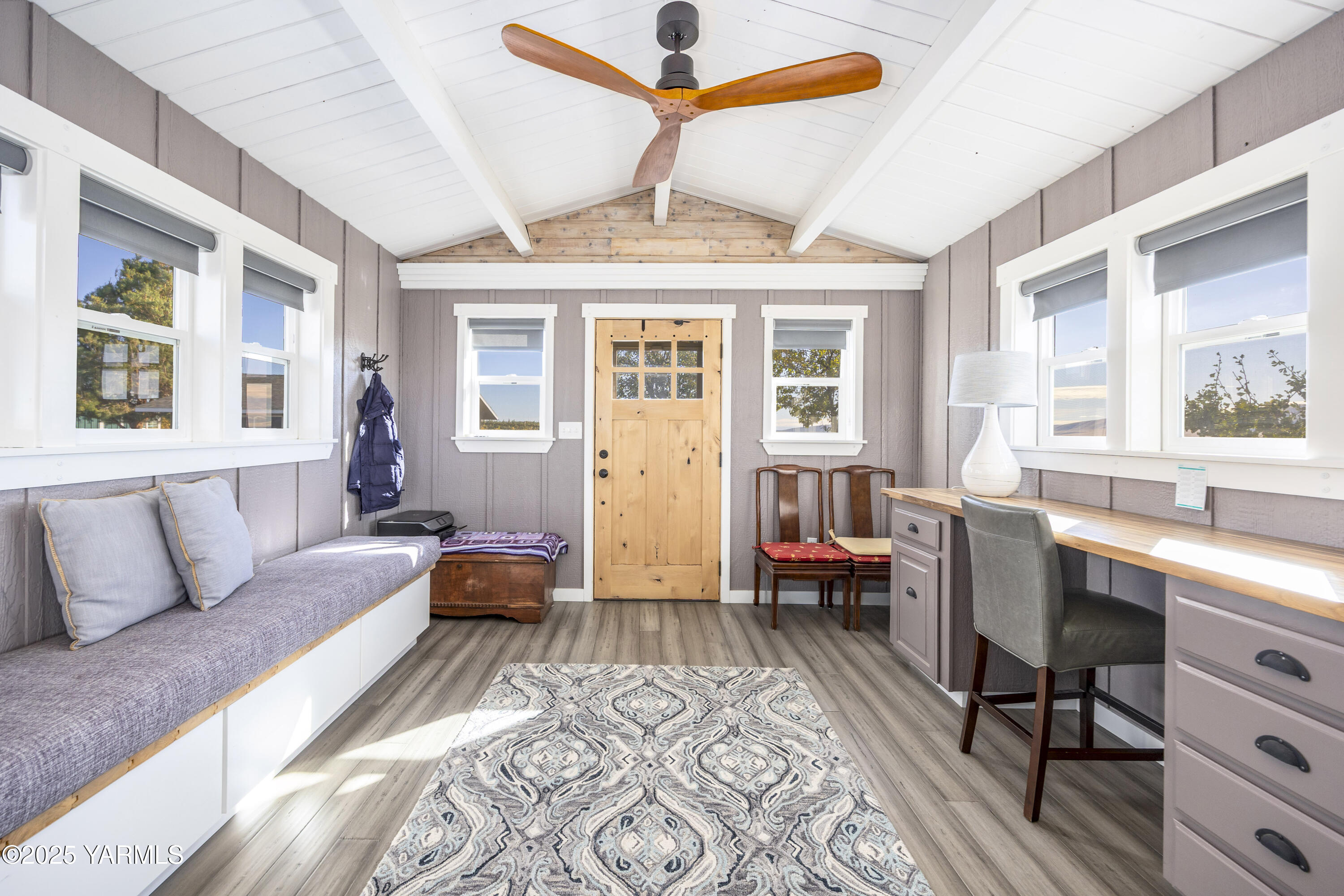 22207 West Gerrick Road Benton City, WA 99320 - Photo 29 of 60 a spacious bedroom with a bed a couch and a window