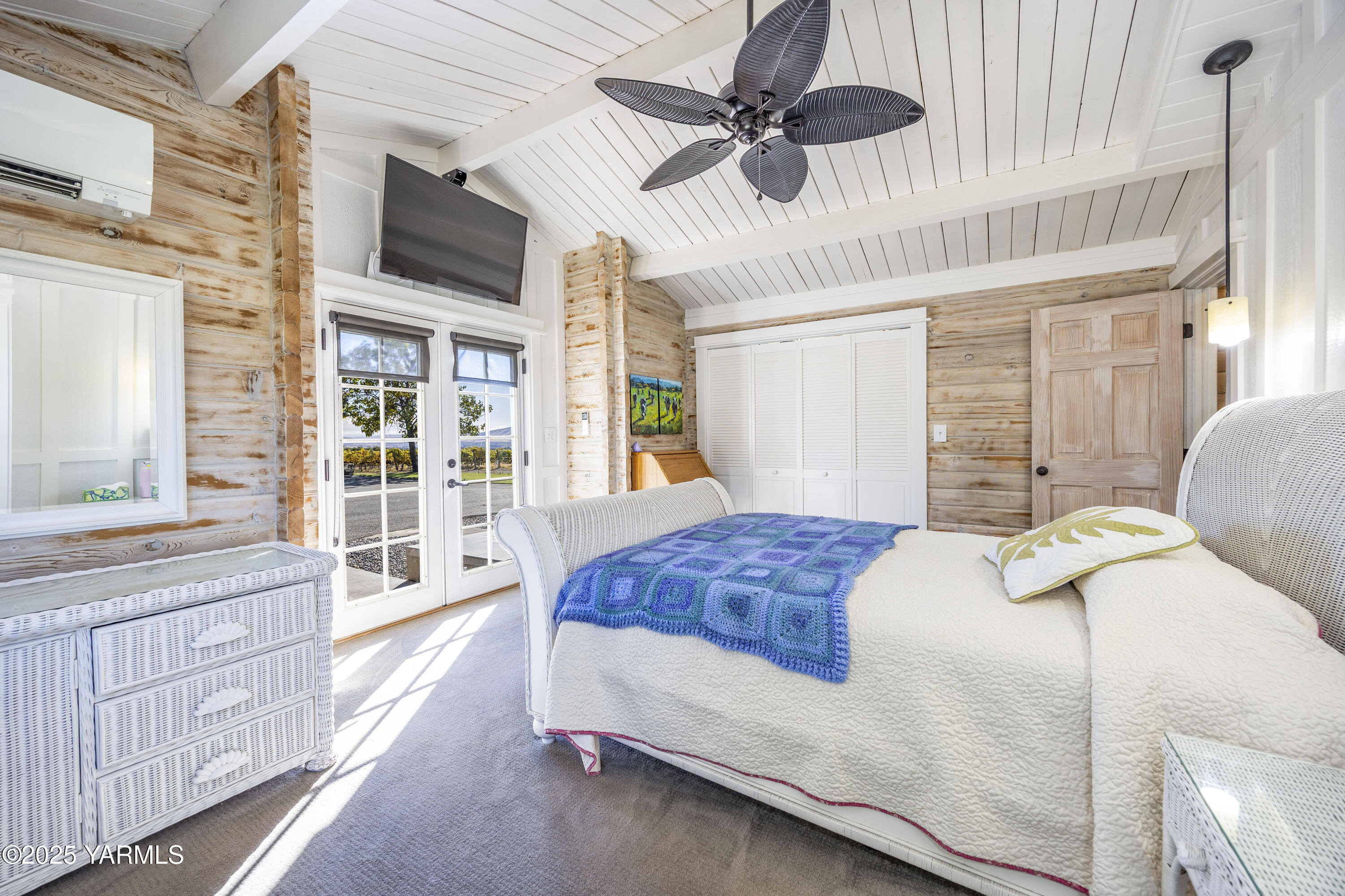22207 West Gerrick Road Benton City, WA 99320 - Photo 32 of 60 a bedroom with a large bed a flat tv screen and a dresser